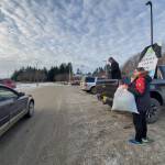 Katie Rich and Joanna Tornes (right) hold a coat drive for Port Graham and Nanwalek in the Homer Public Library parking lot on Saturday, Nov. 23, 2024, in Homer, Alaska. (Delcenia Cosman/Homer News)