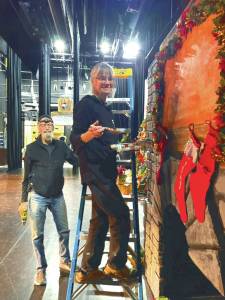 Michael McKinney and Bobby McKinney add finishing touches to the party scene fireplace at the Homer Nutcracker rehearsals on Sunday at the Homer Mariner Theater. (Emilie Springer/ Homer News)