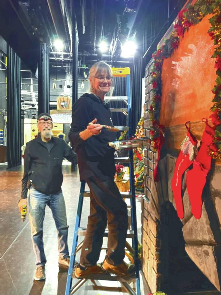 Michael McKinney and Bobby McKinney add finishing touches to the party scene fireplace at the Homer Nutcracker rehearsals on Sunday Dec. 1, 2024, at the Homer Mariner Theater, in Homer, Alaska. (Emilie Springer/ Homer News)