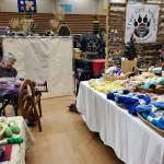 A vendor spins hand-dyed yarn at her booth at Homer Council on the Arts annual Nutcracker Faire on Saturday, Dec. 7, 2024, in the Homer High School gym in Homer, Alaska. (Delcenia Cosman/Homer News)