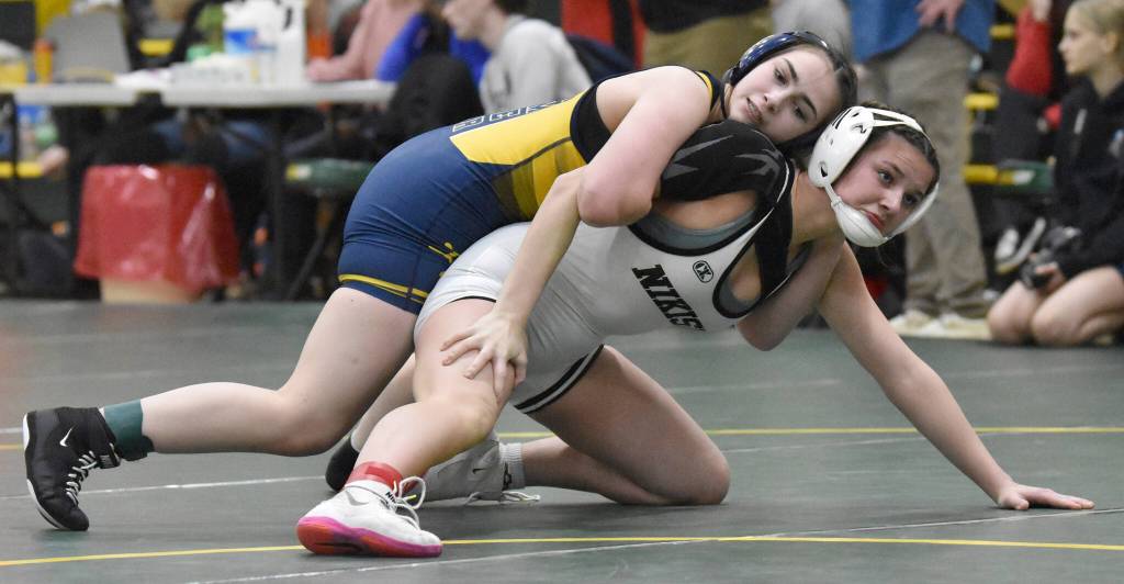 Homers Saoirse Cook wrestles to a win over Nikiskis Braylynn Young in the championship match at 132 pounds at the Kachemak Conference wrestling tournament at Seward High School in Seward, Alaska, on Saturday, Dec. 14, 2024. (Photo by Jeff Helminiak/Peninsula Clarion)