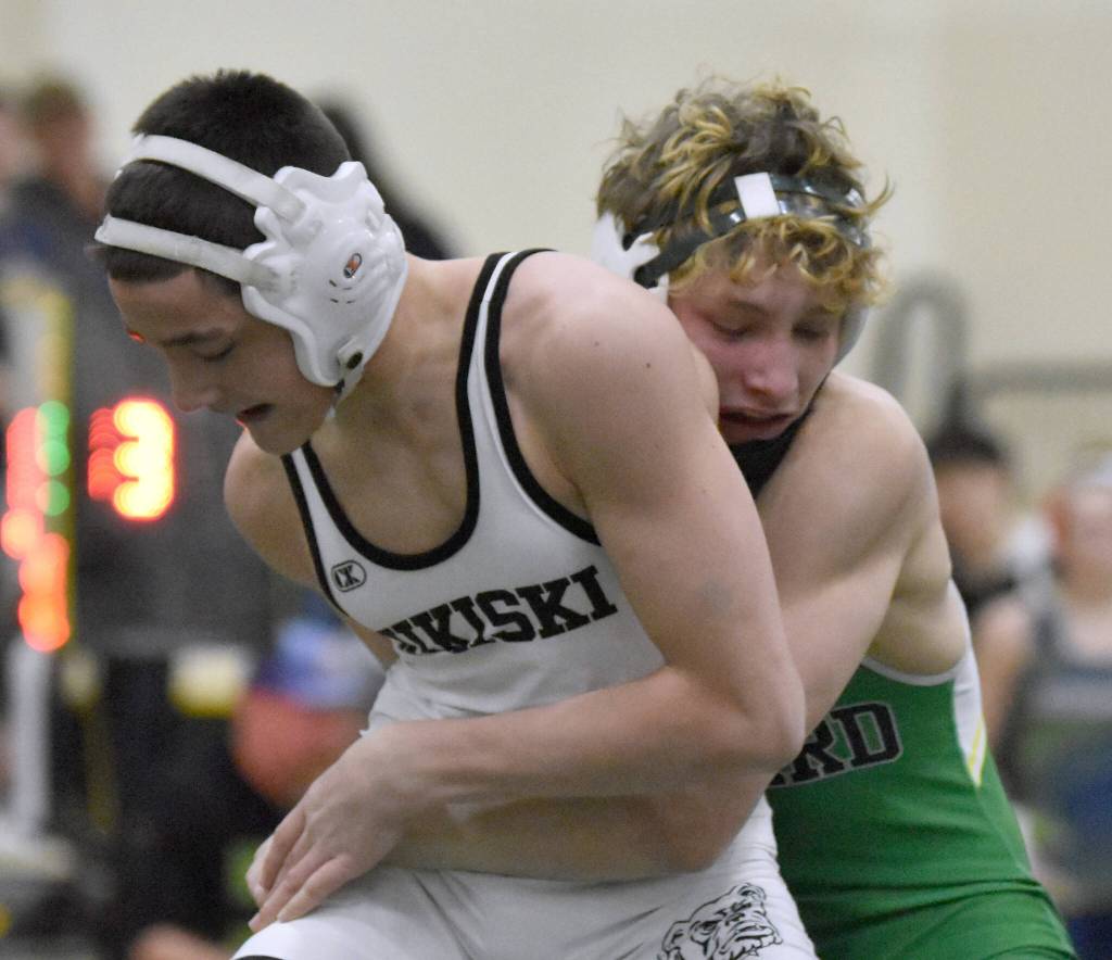 Sewards Hunter Forshee-Kurtz wrestles to a victory over Nikiskis Jaxson Young in the championship match at 135 pounds at the Kachemak Conference wrestling tournament at Seward High School in Seward, Alaska, on Saturday, Dec. 14, 2024. (Photo by Jeff Helminiak/Peninsula Clarion)