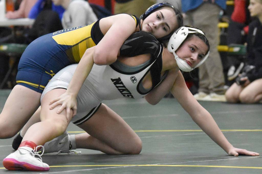 Homer's Saoirse Cook wrestles to a win over Nikiski's Braylynn Young in the championship match at 132 pounds at the Kachemak Conference wrestling tournament at Seward High School in Seward, Alaska, on Saturday, Dec. 14, 2024. (Photo by Jeff Helminiak/Peninsula Clarion)
