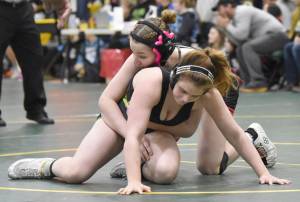 Kenai Centrals Rylee Trent wrestles to a victory over Redingtons Alejandra Roman in the championship match at 138 pounds at the Kachemak Conference wrestling tournament at Seward High School in Seward, Alaska, on Saturday, Dec. 14, 2024. (Photo by Jeff Helminiak/Peninsula Clarion)
