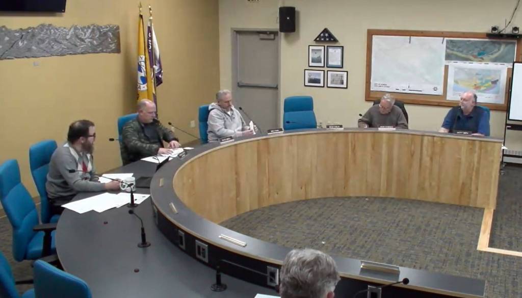 City Planner Ryan Foster (left) reads out a memorandum as a preview to the planning commissions discussion on implementing a moratorium for specific conditional use permit applications on Wednesday, Dec. 4, 2024, in the Homer City Hall Cowles Council Chambers in Homer, Alaska. Screenshot.