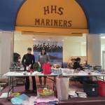 Ella Gustafson, Mariner junior, and Mally Im, senior, wrap presents at the Share the Spirit presentation in the Homer High School Commons on Saturday. Emilie Springer/ Homer News