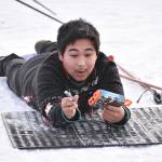 Kenai Central's Kaden Bee loads a bullet at the Candy Cane Scramble on Friday, Dec. 20, 2024, at Tsalteshi Trails just outside of Soldotna, Alaska. (Photo by Jeff Helminiak/Peninsula Clarion)