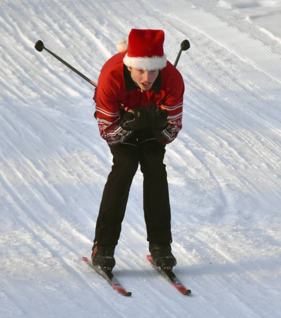Kenai Central's Fletcher Darr cruises down a hill at the Candy Cane Scramble on Friday, Dec. 20, 2024, at Tsalteshi Trails just outside of Soldotna, Alaska. (Photo by Jeff Helminiak/Peninsula Clarion)