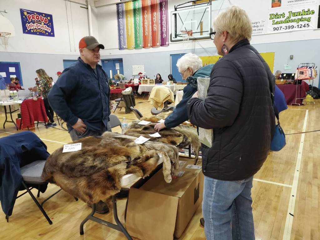 A vendor sells furs, including fox, beaver and more, at the Last-Chance Craft Bazaar held in the Chapman School gym on Saturday, Dec. 21<ins>, 2024,</ins> in Anchor Point<ins>, Alaska</ins>. (Delcenia Cosman/Homer News)