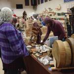 Craft-fair goers browse artwork and goods by Sierra Rae Parker at her booth at the Procrastinators Fair on Saturday, Dec. 21<ins>, 2024,</ins> at Christian Community Church in Homer<ins>, Alaska</ins>. (Delcenia Cosman/Homer News)