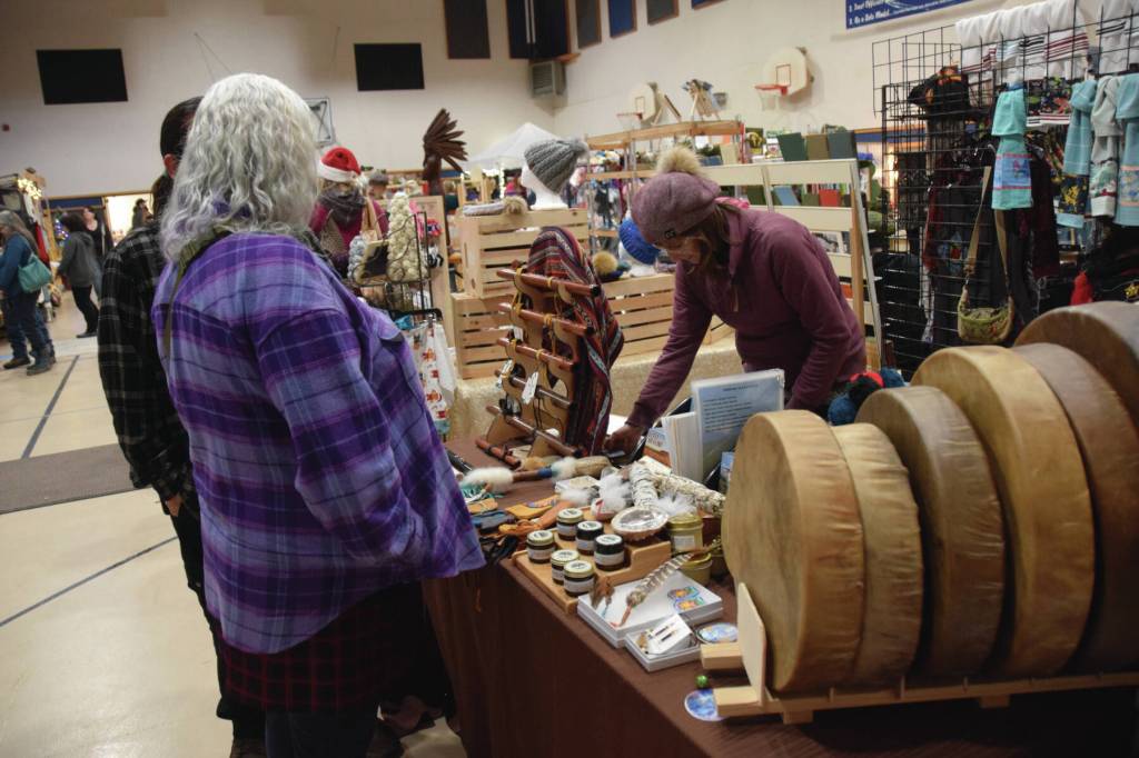 Craft-fair goers browse artwork and goods by Sierra Rae Parker at her booth at the Procrastinators Fair on Saturday, Dec. 21<ins>, 2024,</ins> at Christian Community Church in Homer<ins>, Alaska</ins>. (Delcenia Cosman/Homer News)