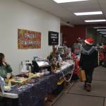 Community members check out the Homer Headstart and Paul Banks Elementary PTA booths at the Procrastinators Fair on Saturday, Dec. 21<ins>, 2024,</ins> at Christian Community Church<ins> in Homer, Alaska</ins>. (Delcenia Cosman/Homer News)