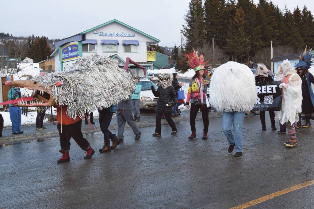 Delcenia Cosman/Homer News
Costumed community members walking with Homer Drawdown puppet a Grubby the Possum marionette, created during Bunnell Street Arts Centers January Makers Space sessions, at the 70th annual Homer Winter Carnival Parade on Pioneer Avenue on Saturday, Feb. 10, 2024 in Homer, Alaska.