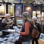 Artist Gary Lyon talks with customers at his booth during the Homer Council on the Arts annual Nutcracker Faire on Saturday, Dec. 7, 2024, in Homer, Alaska. (Delcenia Cosman/Homer News)