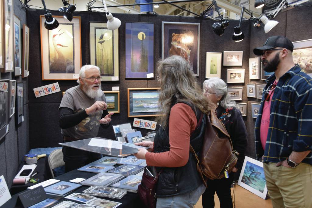 Artist Gary Lyon talks with customers at his booth during the Homer Council on the Arts annual Nutcracker Faire on Saturday, Dec. 7, 2024, in Homer, Alaska. (Delcenia Cosman/Homer News)