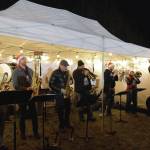 The KP Brass Band plays "Jingle Bells" and other holiday and classic favorites during the Homer Chamber of Commerces annual Christmas tree lighting celebration on Thursday, Dec. 5, 2024, in Homer, Alaska. (Delcenia Cosman/Homer News)