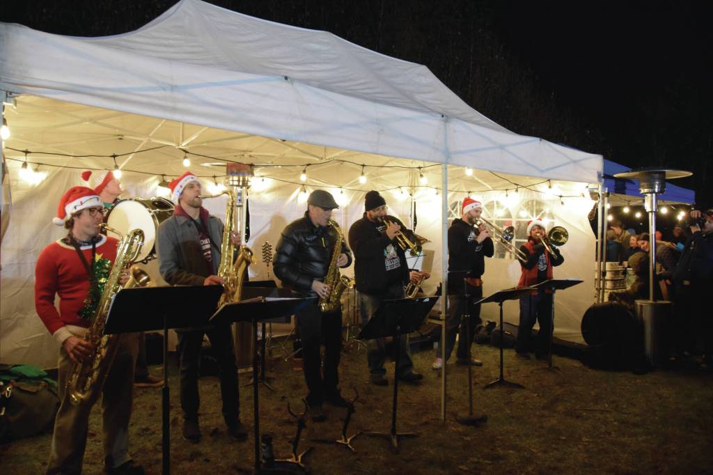 The KP Brass Band plays "Jingle Bells" and other holiday and classic favorites during the Homer Chamber of Commerces annual Christmas tree lighting celebration on Thursday, Dec. 5, 2024, in Homer, Alaska. (Delcenia Cosman/Homer News)