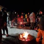 Community members gather around fire pits at the pavilion next door to Great Land Worship Center in Anchor Point, Alaska, to await the New Years Eve fireworks show conducted by the Virl Pa Haga VFW Post 10221 on Dec. 31, 2024. (Delcenia Cosman/Homer News)