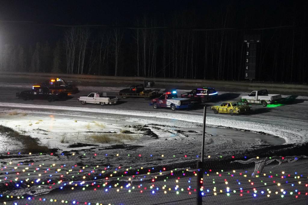 Racers round the track ahead of the start of the first race of the Kenai Peninsula Ice Racing season at Twin City Raceway in Kenai, Alaska, on Tuesday, Dec. 31, 2024. (Jake Dye/Peninsula Clarion)