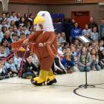 Aubrie Ellis, minutes before being named National Outstanding Assistant Principal of 2025 by the Alaska Association of Elementary School Principals, enters an awards assembly on a scooter and in a eagle costume at Mountain View Elementary School in Kenai, Alaska, on Friday, Jan. 10, 2025. (Jake Dye/Peninsula Clarion)