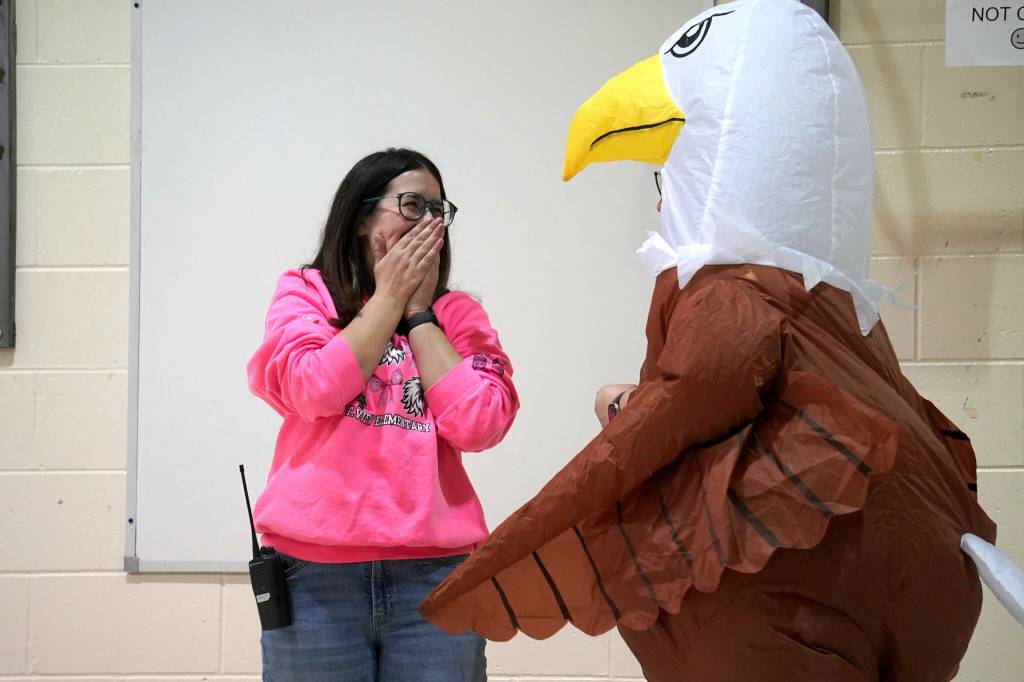 Mountain View Elementary School Principal Hannah Dolphin celebrates as Assistant Principal Aubrie Ellis, in the eagle, is named National Outstanding Assistant Principal of 2025 by the Alaska Association of Elementary School Principals at Mountain View Elementary School in Kenai, Alaska, on Friday, Jan. 10, 2025. (Jake Dye/Peninsula Clarion)