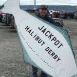 Tim Hatfield poses with the Homer Halibut Derby sign in this undated photo on the Homer Spit in Homer, Alaska. Photo provided by Tim Hatfield