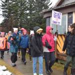 Marchers carry signs in the Homer Womens March on Saturday, Jan. 18, 2025, on Pioneer Avenue in Homer, Alaska. (Delcenia Cosman/Homer News)
