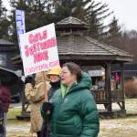 A woman carrying a sign that says Girls Just Wanna Have Fundamental Rights gathers with other marchers at WKFL Park in Homer, Alaska, at the conclusion of the Homer Womens March on Saturday, Jan. 18, 2025. (Delcenia Cosman/Homer News)