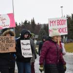 Marchers carry signs in the Homer Womens March on Saturday, Jan. 18, 2025, on Pioneer Avenue in Homer, Alaska. (Delcenia Cosman/Homer News)