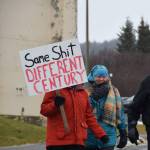 A woman carries a sign that says Same Shit, Different Century during the Homer Womens March on Saturday, Jan. 18, 2025, in Homer, Alaska. (Delcenia Cosman/Homer News)