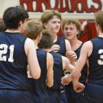 The Homer Mariners celebrate a game-winning shot by Henry Wedvik (front and center) Tuesday, Jan. 21, 2025, at Kenai Central High School in Kenai, Alaska. (Photo by Jeff Helminiak/Peninsula Clarion)
