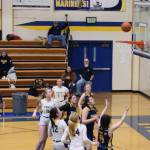 Players watch in anticipation on Saturday, Jan. 25, 2025, as a ball makes it way towards another score for the Homer Mariners. (Chloe Pleznac/Homer News)