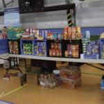 Tables are lined with free food during the annual Community Resource Connect event at the SPARC building on Jan. 28, 2025, in Homer, Alaska. (Chloe Pleznac/Homer News)
