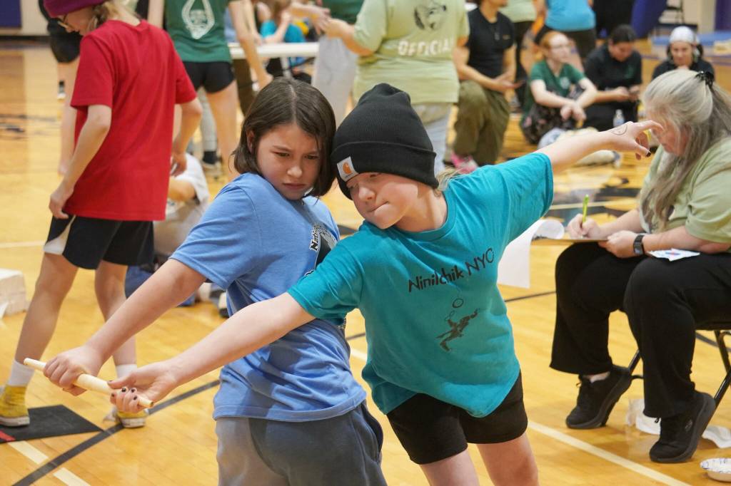 Athletes compete in the Dene stick pull during the Kahtnuhtana Hey Chiula Native Youth Olympics Invitational at Skyview Middle School near Soldotna, Alaska, on Sunday, Jan. 26, 2025. (Jake Dye/Peninsula Clarion)
