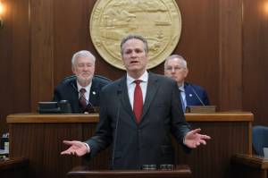 Gov. Mike Dunleavy delivers his State of the State speech at the Alaska State Capitol on Tuesday, Jan. 28, 2025, with Senate President Gary Stevens, at left, and House Speaker Bryce Edgmon, at right, in the background. (Klas Stolpe/Juneau Empire)