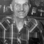 Photo from In Those Days: Alaska Pioneers of the Lower Kenai Peninsula, Vol. II
Poopdeck Platt smiles for the camera in his well-stocked Homer cellar of homemade wines.