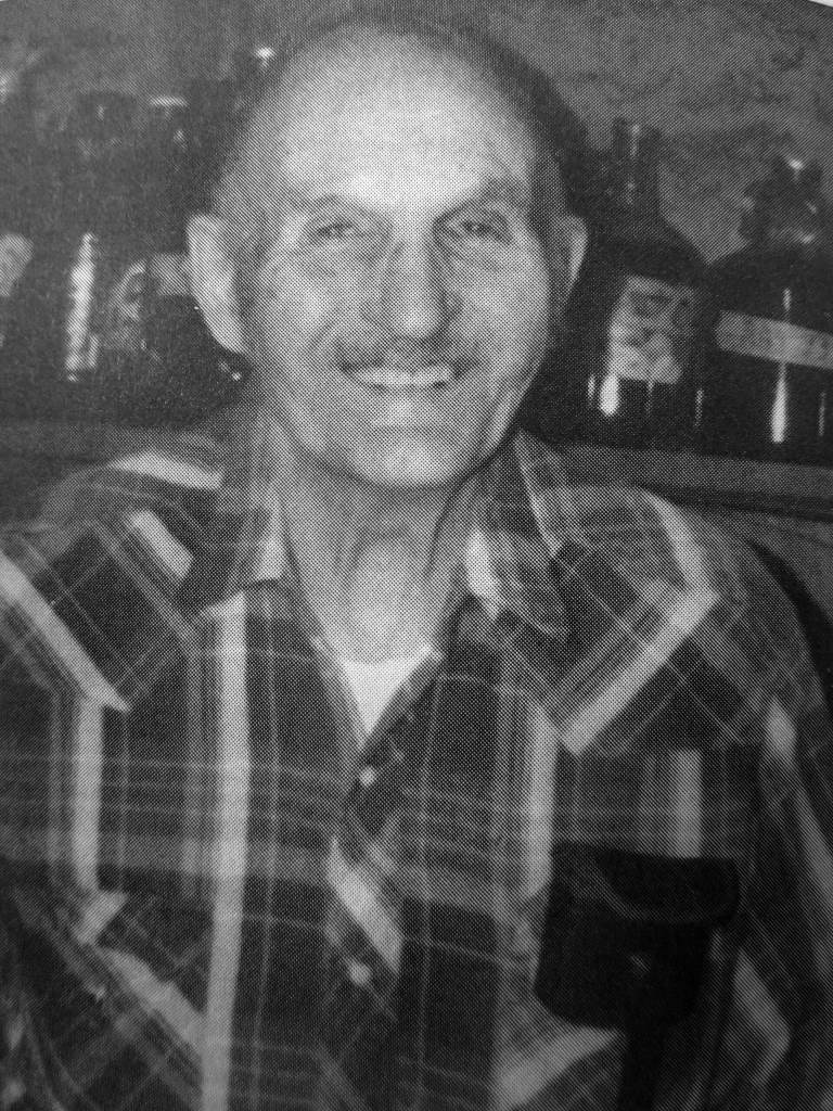 Photo from In Those Days: Alaska Pioneers of the Lower Kenai Peninsula, Vol. II
Poopdeck Platt smiles for the camera in his well-stocked Homer cellar of homemade wines.