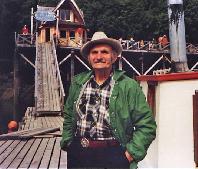 Photo courtesy of Ken Moore
In the 1990s, Poopdeck Platt enjoys some sunshine in front of The Saltry, in Halibut Cove.