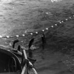 In this undated photograph, Poopdeck Platt, wearing his old Stetson, watches from his fishing vessel, the Hummingbird, as the salmon begin to come aboard. (Photo courtesy of Ken Moore)