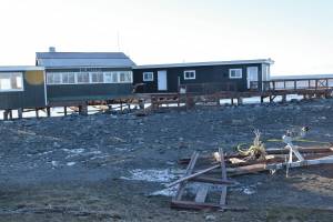 Debris and damage to the Glacier D restaurant is seen on Monday, Nov. 18, 2024, following a storm event that caused erosion damage to the Homer Spit on Saturday in Homer, Alaska. (Delcenia Cosman/Homer News)