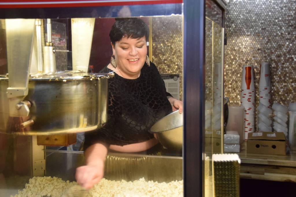 An event staff member serves up fresh popcorn during The Porcupine Theaters grand reopening gala on Friday, Jan. 31, 2025, in Homer, Alaska. (Delcenia Cosman/Homer News)