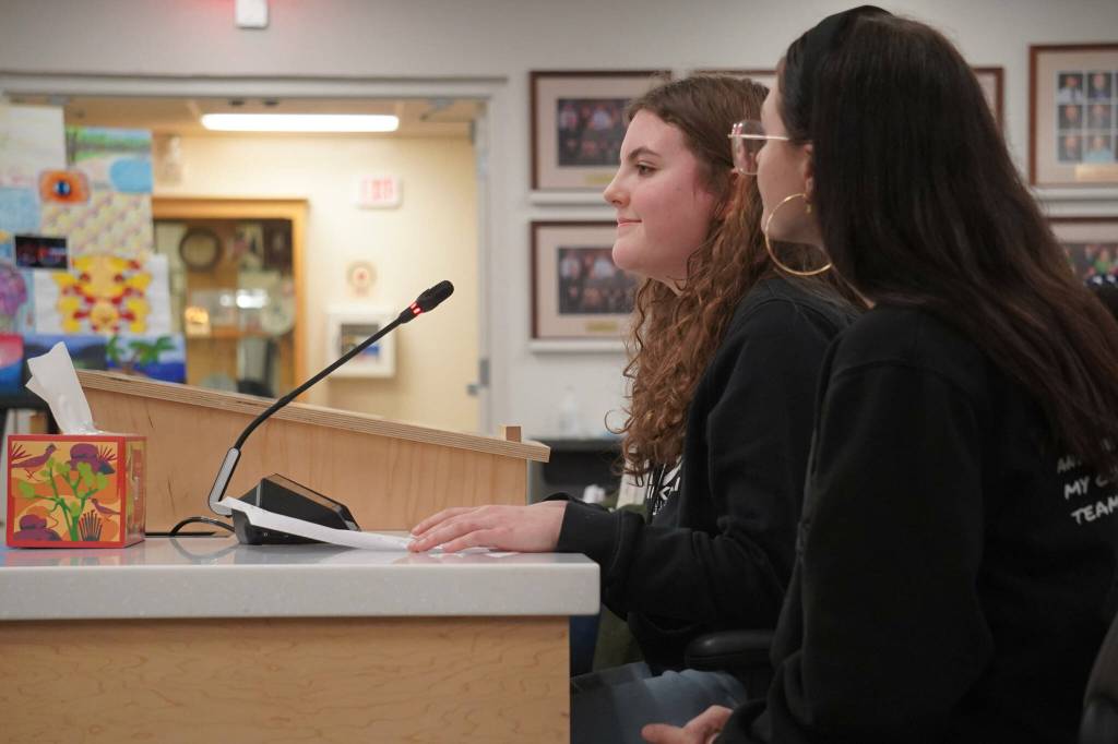 Milly Hornung and Halle Blades speak in opposition to a possible closure of Nikiski Middle/High School during a meeting of the Kenai Peninsula Borough School District in Soldotna, Alaska, on Monday, Feb. 3, 2025. (Jake Dye/Peninsula Clarion)