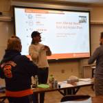 Tyler T Moskios-Schlieman demonstrates a dance developed with Homer Flex students to better remember the tMHFA 5-step action plan at the Planet Youth Homer event hosted Thursday, Jan. 6, 2025, at Kachemak Bay Campus in Homer, Alaska. (Chloe Pleznac/Homer News)