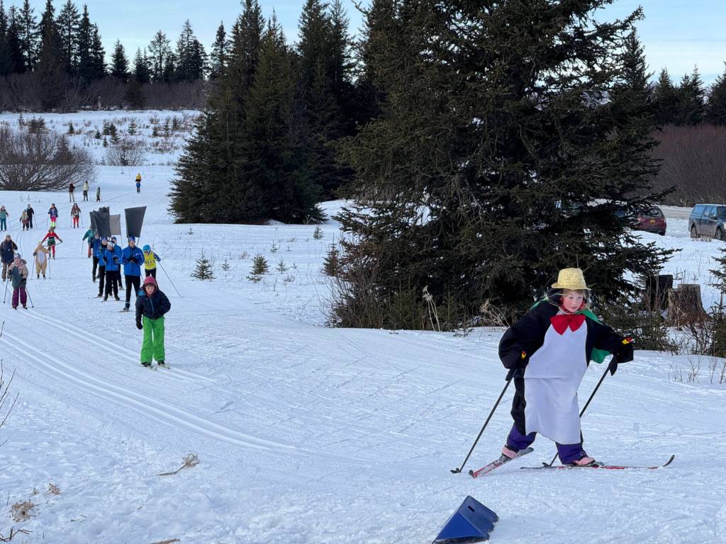 A penguin wearing a golden top hat leads the pack on Sunday, Feb. 9 during the annual Ski for Women fundraiser at the Lookout Mountain XCS Trails on Ohlson Mountain. (Chloe Pleznac/Homer News)