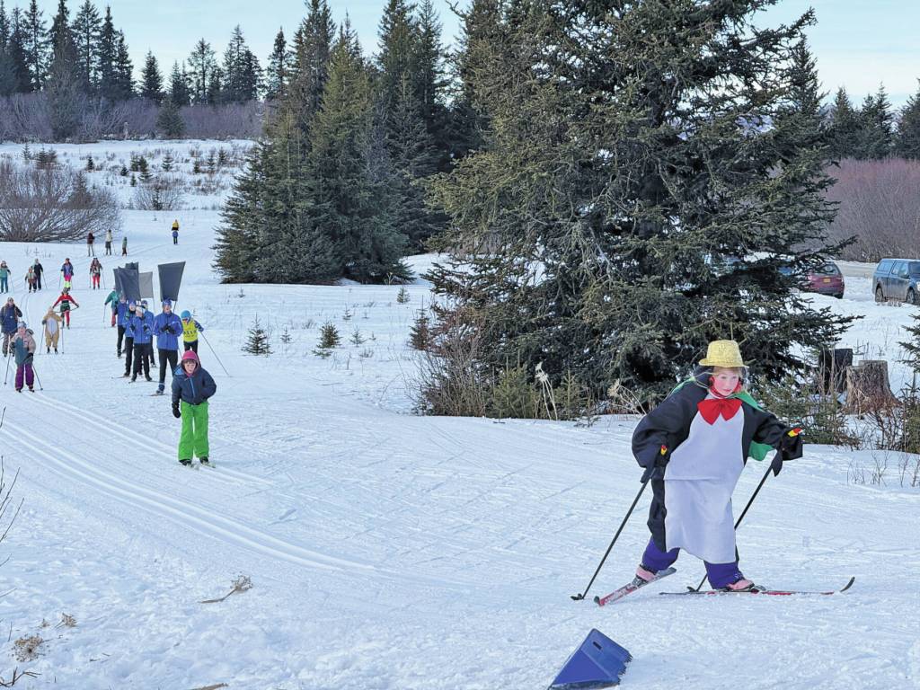 A penguin wearing a golden top hat leads the pack on Sunday, Feb. 9 during the annual Ski for Women fundraiser at the Lookout Mountain XCS Trails on Ohlson Mountain. (Chloe Pleznac/Homer News)