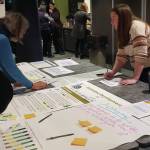 City of Homer Community Development Director Julie Engebretsen (right) explains the economic development aspects of the draft 2035 comprehensive plan during an open house event on Tuesday, Feb. 11<ins>, 2025,</ins> at the Alaska Maritime National Wildlife Refuge Visitor Center<ins> in Homer, Alaska</ins>. (Delcenia Cosman/Homer News)