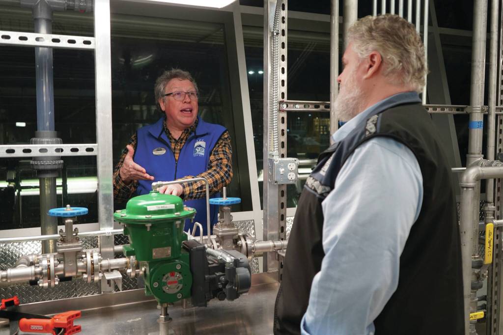 Professor of Process Technology Jeffrey Laube explains equipment to Kachemak Bay Campus Director Brian Partridge at a showcase of Kenai Peninsula Colleges career and technical education programs in the colleges Career and Technical Center in Soldotna on Thursday, Feb. 20. (Jake Dye/Peninsula Clarion)