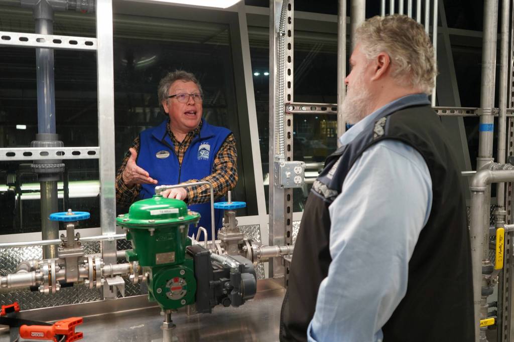 Professor of Process Technology Jeffrey Laube explains equipment to Kachemak Bay Campus Director Brian Partridge at a showcase of Kenai Peninsula Colleges career and technical education programs in the colleges Career and Technical Center in Soldotna, Alaska, on Thursday, Feb. 20, 2025. (Jake Dye/Peninsula Clarion)