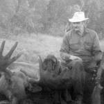 Photo from In Those Days: Alaska Pioneers of the Lower Kenai Peninsula, Vol. II
Clarence Hiram Poopdeck Platt sits atop a recent moose kill.
