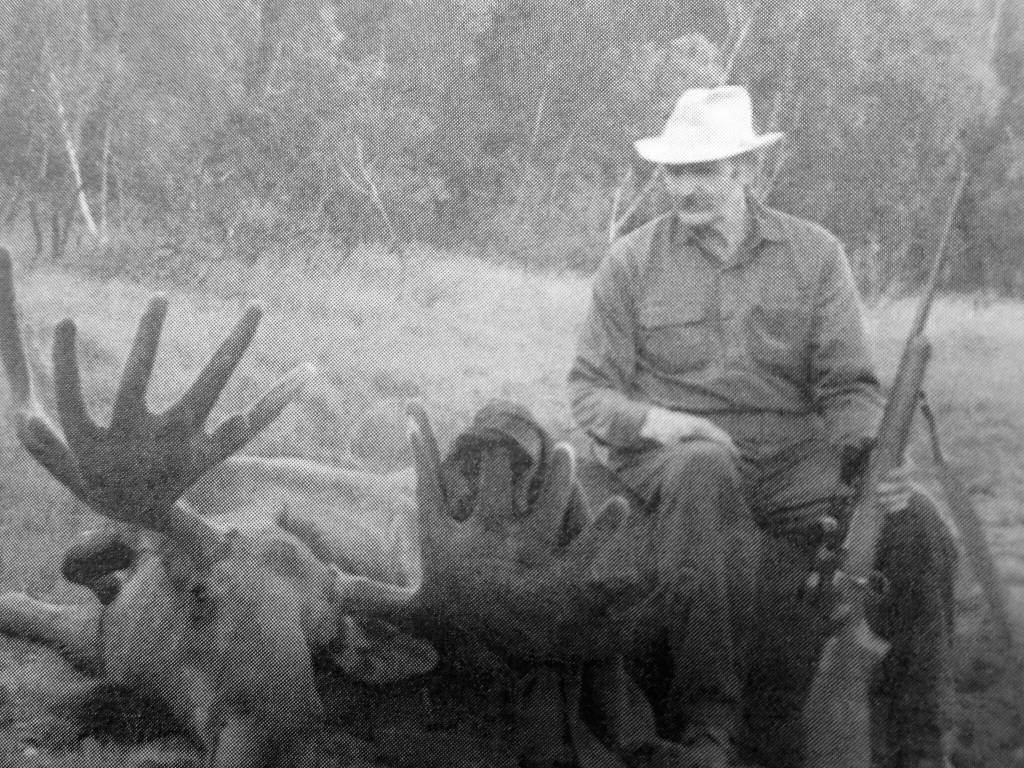 Photo from In Those Days: Alaska Pioneers of the Lower Kenai Peninsula, Vol. II
Clarence Hiram Poopdeck Platt sits atop a recent moose kill.